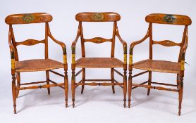 A set of six early 19th Century satinwood and decorated elbow chairs:, with painted ebonised lines,