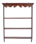 An oak plate rack in the 18th Century taste:, with a moulded cornice and shaped fret cut apron,