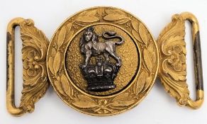A Victorian Royal Artillery belt buckle: the centre with silver lion passant on a Queen's crown on