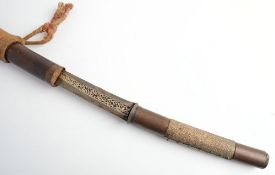 A 19th century Burmese Dha: the slightly curved blade with niello style decoration to ricasso over