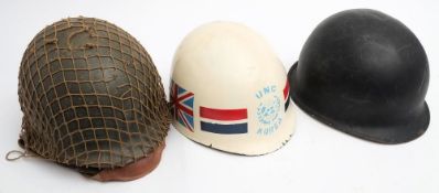 Two American M1 pattern steel helmets: and a white fibreglass M1 pattern liner painted with 'UNC