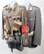 A reproduction German army tunic, decorated with badges,