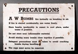 A WWII enamel sign 'Precautions A W Bombs': black text on white ground, 20.5 x 30.