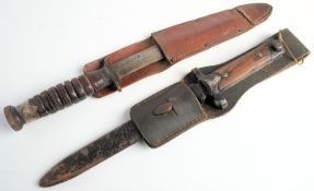 A WWII American M3 Utica fighting knife: clipped back blade stamped 'US M3 Utica' steel hilt and
