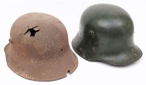 A German M1918 pattern Stahlhelm (steel helmet): overpainted in dark green,