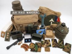 A collection of various militaria: comprising cloth patches, canvas bags and webbing,