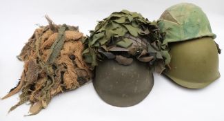 A group of five British and American pattern steel helmets: two with camouflage (5)