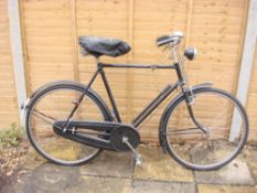 A 1950s Raleigh bicycle: black frame with frame mounted Sturmey Archer three speed gears,