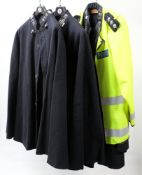 Three Devon and Cornwall Constabulary capes and a later Police high visibility vest: