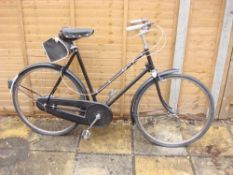 A Raleigh lady's bicycle: all steel step through black frame, Sturmey Archer three speed gears,