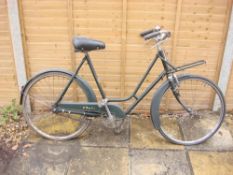 A mid 20th century BSA Shopper bicycle: green step through frame,chrome plated handlebars,