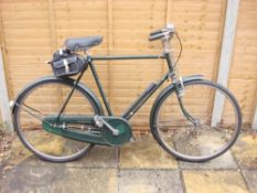 A 1950s Raleigh 'Superbe' Roadster bicycle: original green step frame with decals,