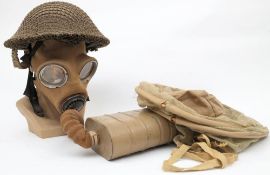 A British Army Brodie pattern steel helmet with net cover: together with a WWII No 4 type gas mask
