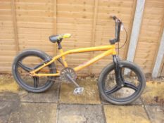 A Diamondback Session BMX bike:, yellow frame with black front forks and handlebars, lever brakes,