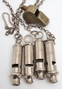 A War Department issue 'The Metropolitan' whistle: together with three J Hudson & Co 'ARP' whistles