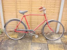 A GPO Armstrong bicycle: red frame with chrome handlebars and bar brakes,