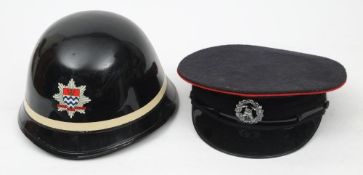 A mid 20th century London Fire Brigade black lacquer helmet by George Angus & Co: with single white