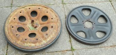 Two unidentified cast iron armoured vehicle wheels: one with solid rubber tyre (2)