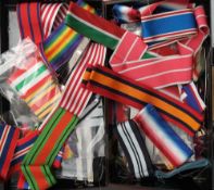 A quantity of various medal ribbons and bars in a tin box: