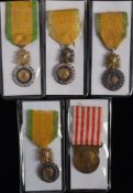 A group of four Medal Militaire with trophy suspension: together with a Commemorative Medal of the