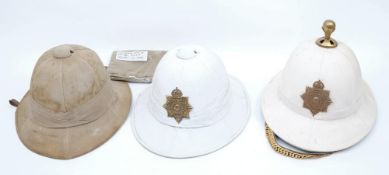 Two 20th century Royal Marine Wolseley pattern pith helmets: one with gilt brass ball final,