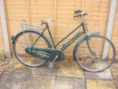 A Raleigh 'All Steel Model' lady's bicycle: the green step through frame with original decals,