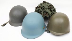 Two M51 pattern steel helmets together with a reproduction Russian steel helmet: and one other