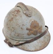 A WWI French Artillery Adrian pattern steel helmet: painted light blue with attached comb and