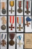 Two WWII German Hindenberg Cross Medals: together with a WWII West Wall Medal and a group of
