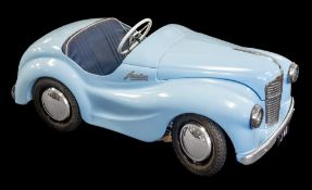 An Austin J40 pedal car: light blue with dark blue upholstery and chrome trim,