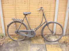 A 1930s Swift bicycle: step through frame, plated handlebars, bar brakes, black leather saddle,