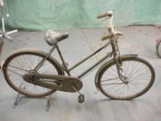 A Raleigh all steel bicycle: step through frame with frame mounted Sturmey Archer three speed gears,