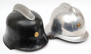 A German polished steel M35 pattern Fire Service helmet: of one piece construction with brass badge