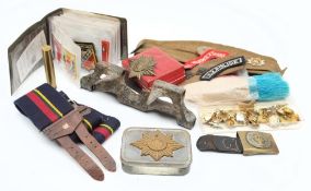 A collection of WWII button and shoulder badges: together with a Devonshire Regiment forge cap,