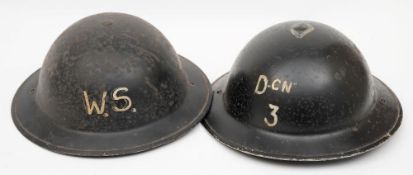 Two WWII Brodie pattern steel helmets: one inscribed 'DCN 3' with single diamond around crown