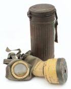 A German GM30 pattern gas mask: green rubber lined canvas mask with metal mounted lenses and filter,