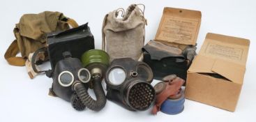 A group of WWII period British civilian gas masks and gas mask boxes: (poor condition)