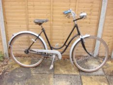 An early 20th century Peugeot lady's bicycle: the black step through frame with silver painted bars,