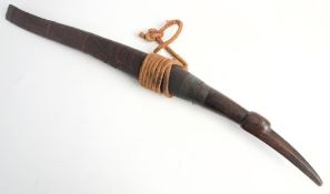 A 19th century Burmese Dha: the slightly curved blade with copper bound hilt and bird's head