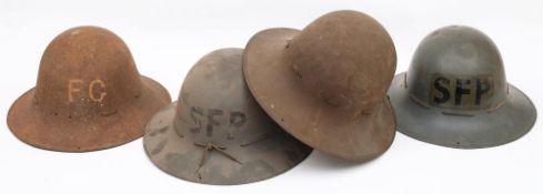 A group of four WWII Zuckerman CPH helmets: two marked 'SFP; one marked 'FG' the other unmarked,
