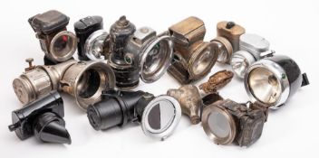 A collection of vintage bicycle lamps: various makers including a Lucas 'New Holophote' and others.