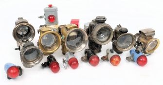 A group of seven various early 20th century bicycle lamps: including a Military lamp,