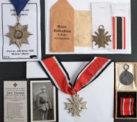 A German silver 'Meister' Star , 1925: together with a WWII Merit Cross with envelope of issue,