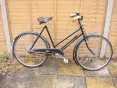 An early 20th century 'The Sun' bicycle: step through frame, black painted handlebars, bar brakes,