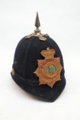 A blue cloth helmet: with silver plated cross piece, spike and rose bosses,