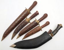 An ebony handled kukri in black leather scabbard,