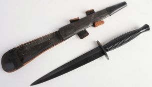 A Fairbairn Sykes pattern fighting knife: straight double edged blade over one piece hilt and cast