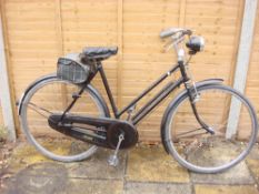 A Raleigh All Steel bicycle,: the black step through frame with red coach lines, plated handlebars,