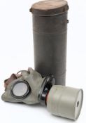 A WWII period Czechoslovakian Fatra Gas mask in tin: grey rubber mask with black metal mounted