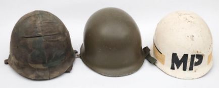A post war period American M51 pattern Military Police steel helmet: over painted white with 'MP'